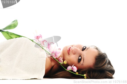 Image of beautiful young  woman face with flower and towel