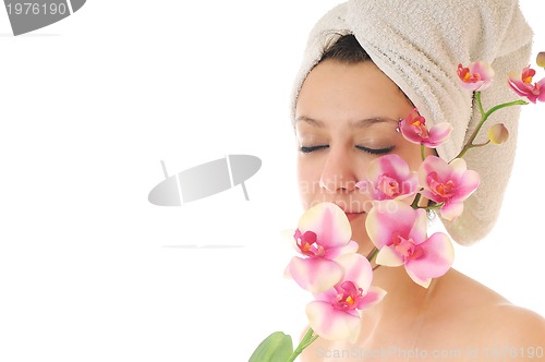 Image of beautiful young  woman face with flower and towel