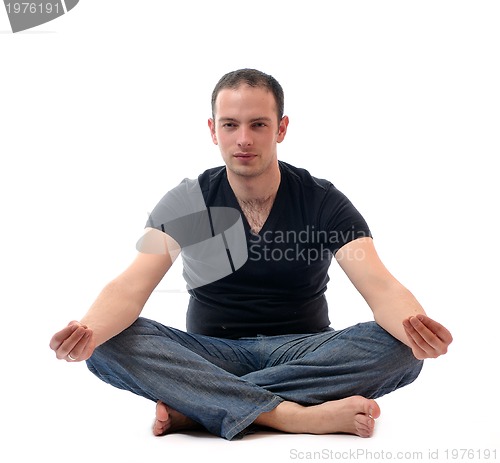 Image of young man in lotus position exercising yoga