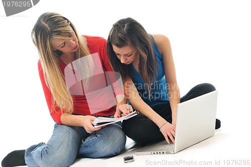 Image of two young girls work on laptop isolated