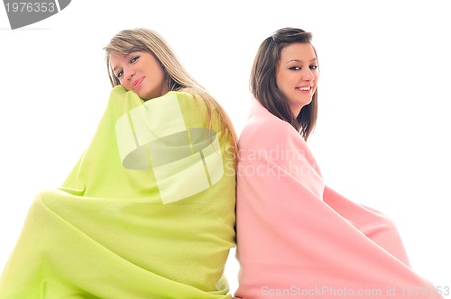 Image of young girls under blanket smile