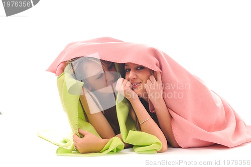 Image of young girls under blanket smile