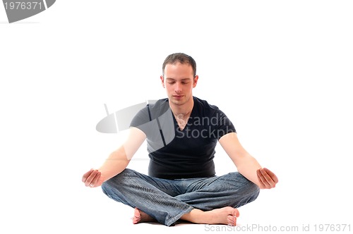 Image of young man in lotus position exercising yoga