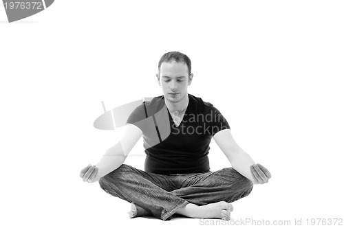 Image of young man in lotus position exercising yoga