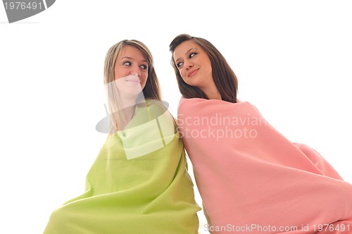 Image of young girls under blanket smile 