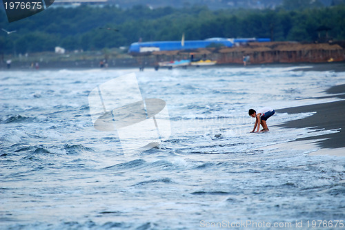 Image of childs having fun on beach at early morning