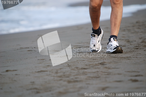 Image of man walking on beach