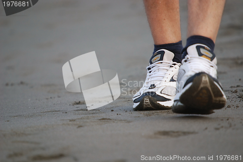 Image of man walking on beach