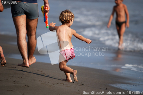 Image of little girl running at the beach