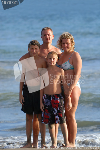 Image of family portrait on beach at summer holidays