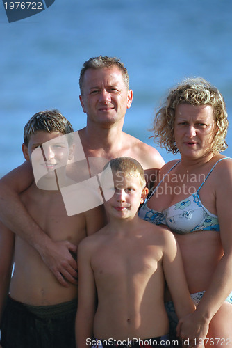 Image of family portrait on beach at summer holidays