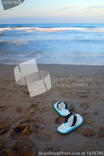 Image of sandals on beach with long exposure