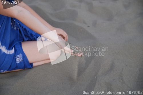 Image of fine sand leaking trought woman hands