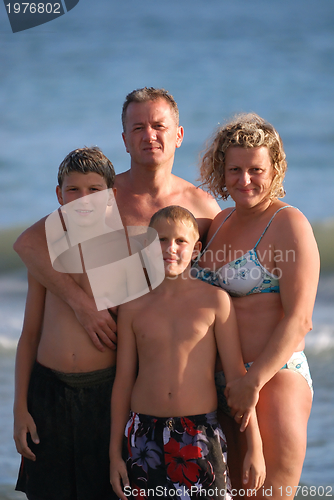 Image of family portrait on beach at summer holidays