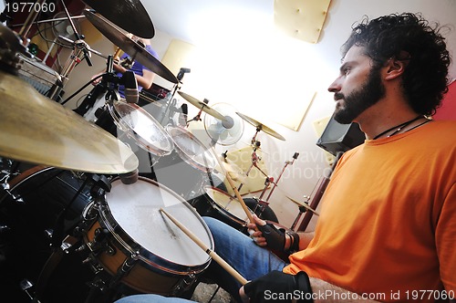 Image of music band have training in garage