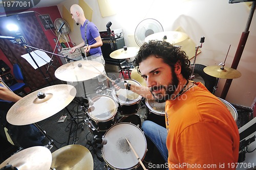 Image of music band have training in garage