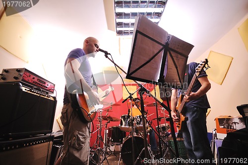 Image of music band have training in garage