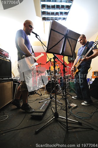 Image of music band have training in garage