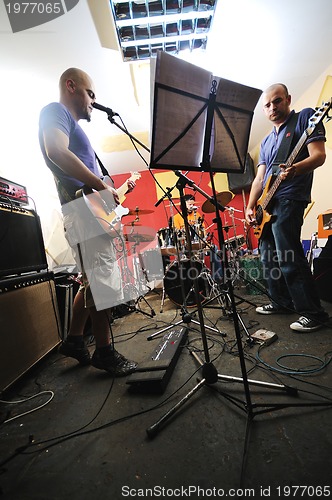 Image of music band have training in garage