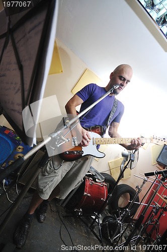 Image of music band have training in garage