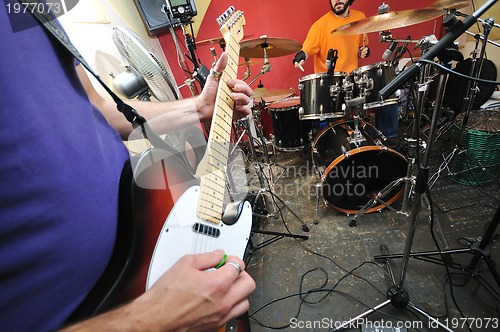 Image of music band have training in garage