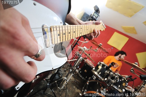 Image of music band have training in garage