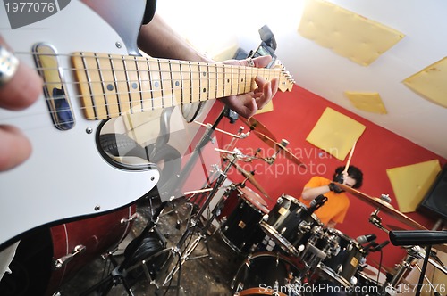 Image of music band have training in garage