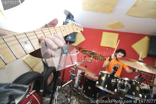 Image of music band have training in garage