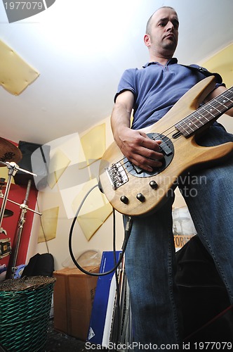 Image of music band have training in garage