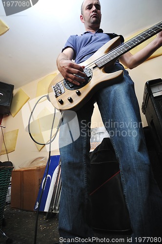 Image of music band have training in garage