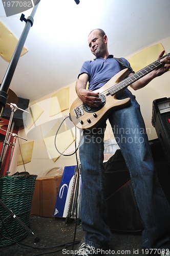 Image of music band have training in garage