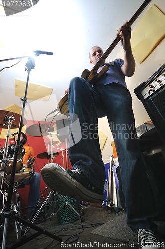 Image of music band have training in garage