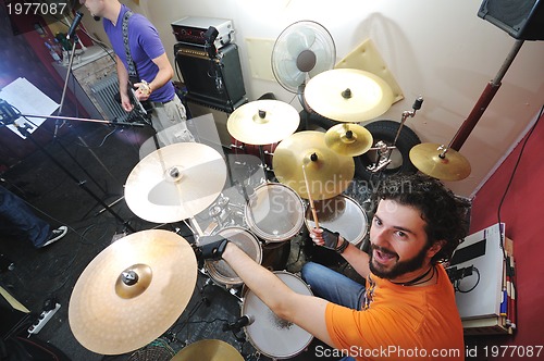 Image of music band have training in garage