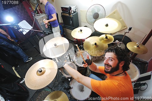 Image of music band have training in garage