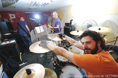 Image of music band have training in garage