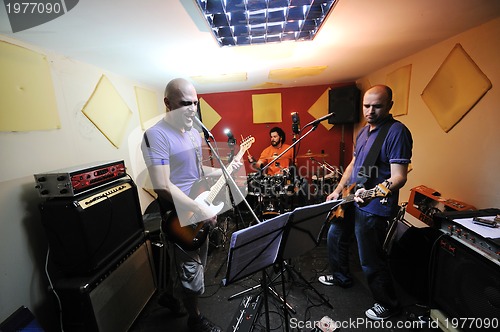 Image of music band have training in garage