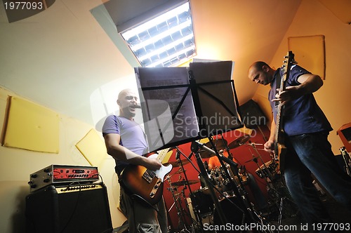 Image of music band have training in garage