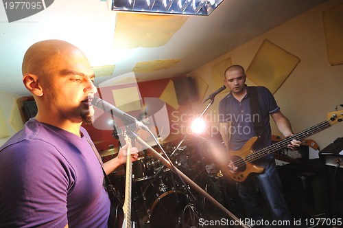 Image of music band have training in garage