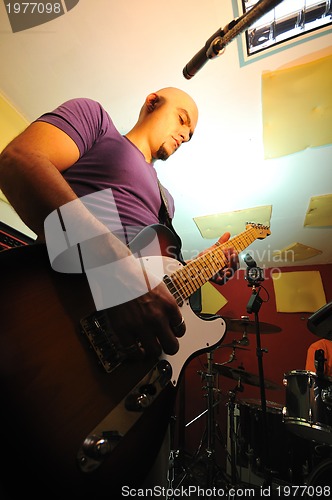 Image of music band have training in garage