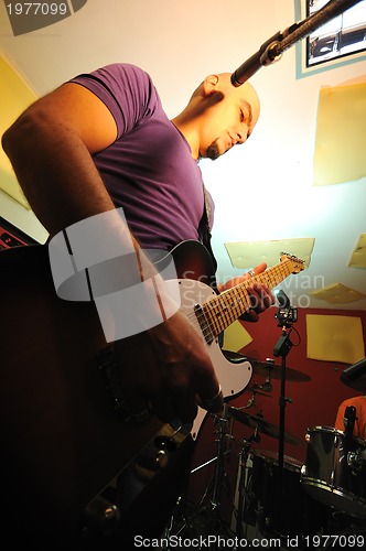 Image of music band have training in garage