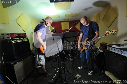 Image of music band have training in garage