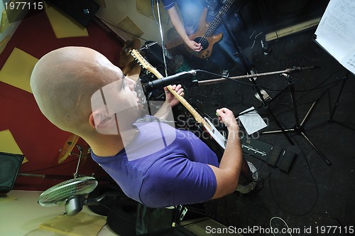 Image of music band have training in garage