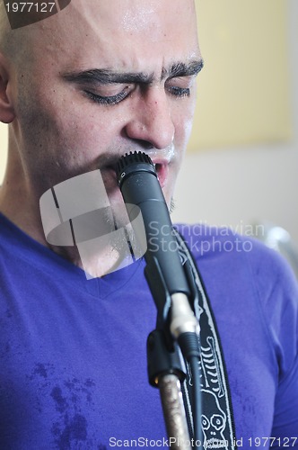 Image of music band have training in garage