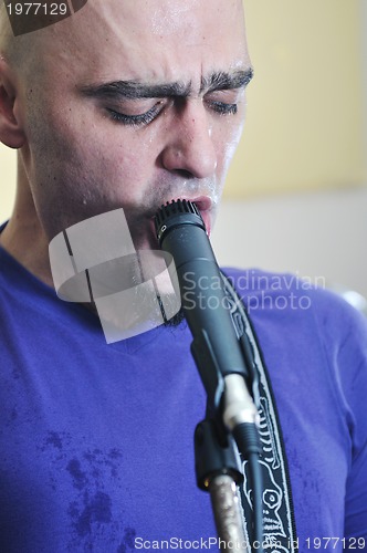 Image of music band have training in garage