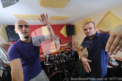 Image of music band have training in garage