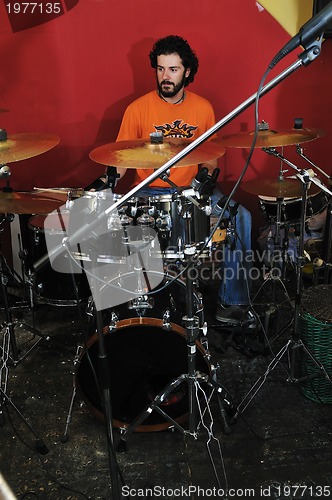 Image of music band have training in garage