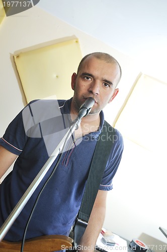 Image of music band have training in garage