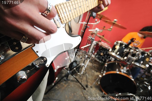 Image of music band have training in garage