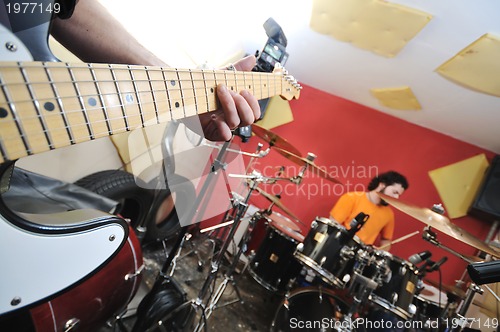 Image of music band have training in garage