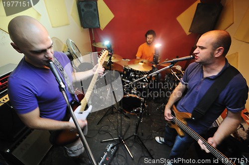 Image of music band have training in garage